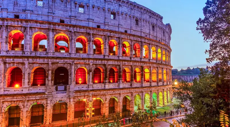 The Colosseum's arches illuminated in warm light at dusk