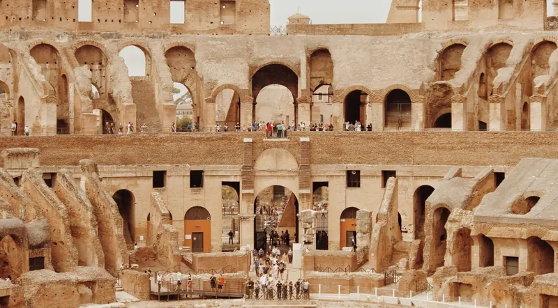 The Colosseum's underground hypogeum and tiered seating with visitors