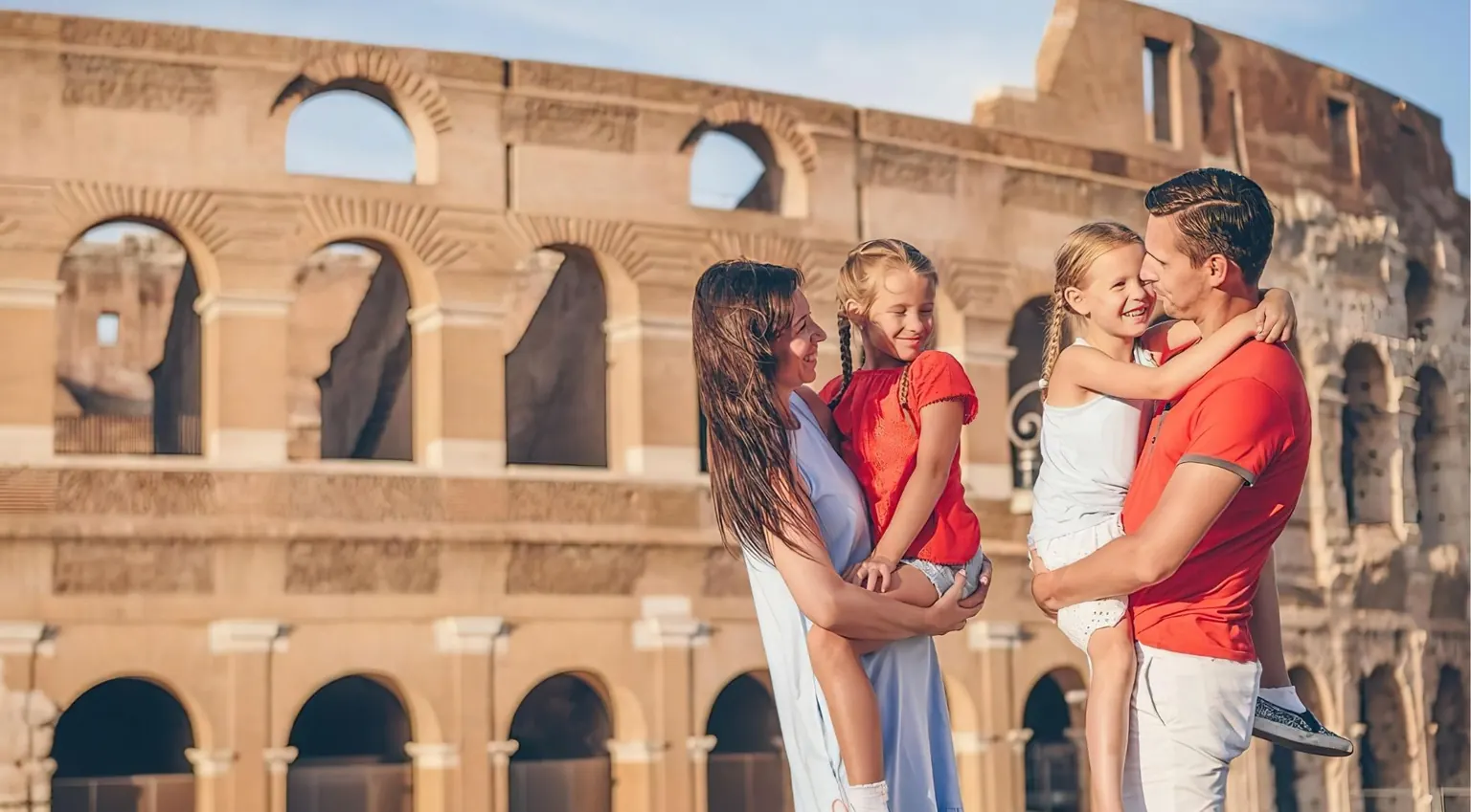 Family with two young daughters in front of the Colosseum in golden evening light
